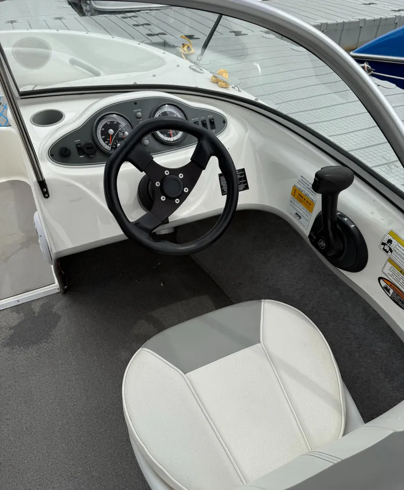Slide: The Image of 2013 Bayliner 160 Bowrider cockpit with steering wheel and controls. - 5
