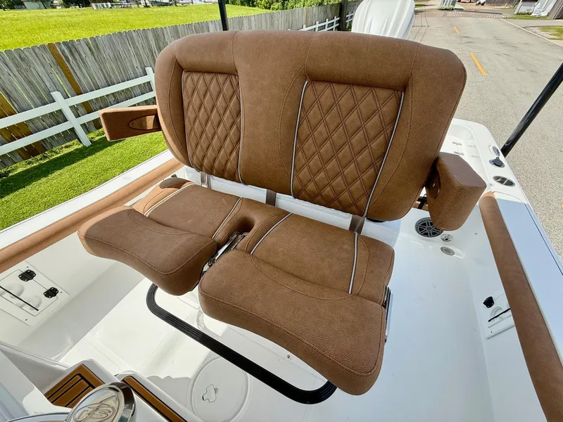 Slide: The Image of 2026 Sea Hunt BX 25 FS boat with brown cushioned seating and diamond stitching. - 10