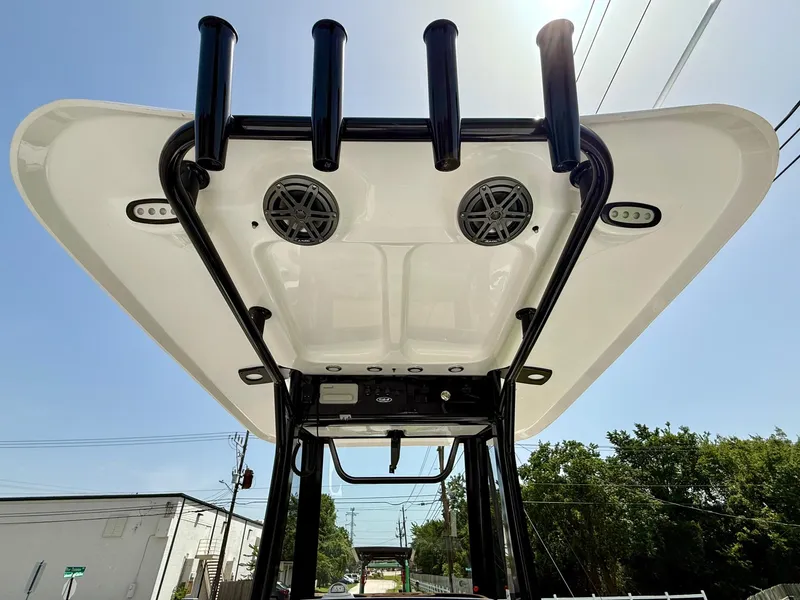 Slide: The Image of 2026 Sea Hunt BX 25 FS boat T-top with rod holders and speakers, viewed from below. - 12