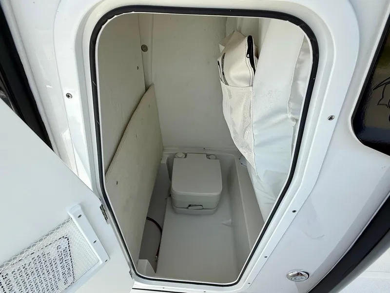 Slide: The Image of 2026 Sea Hunt BX 25 FS boat interior with compact marine toilet. - 14