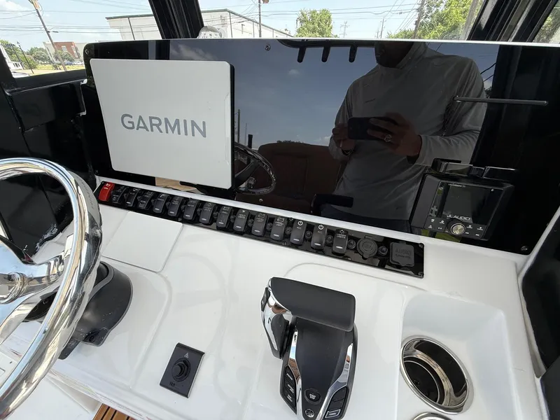 Slide: The Image of 2026 Sea Hunt BX 25 FS boat dashboard with Garmin display and controls. - 19