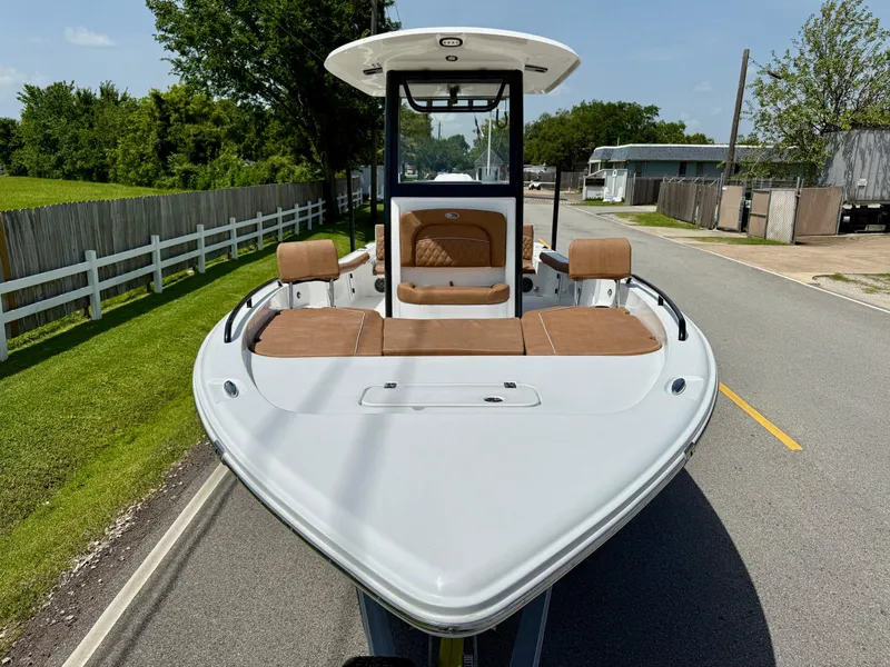 Slide: The Image of 2026 Sea Hunt BX 25 FS boat on road, featuring sleek design and brown seating. - 6