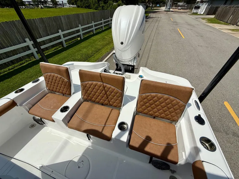 Slide: The Image of 2026 Sea Hunt BX 25 FS boat with brown cushioned seats and white deck. - 7