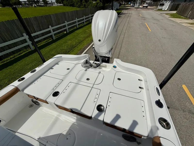 Slide: The Image of 2026 Sea Hunt BX 25 FS boat with outboard motor on a road. - 8