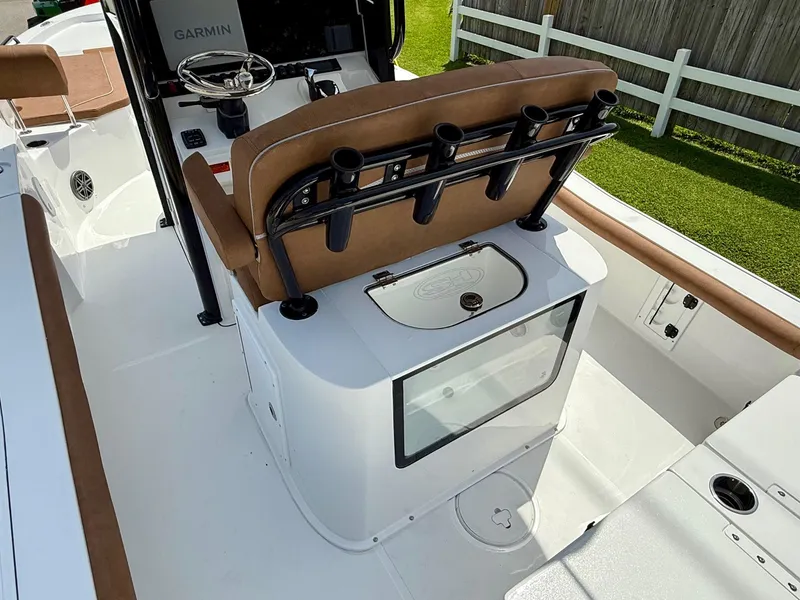 Slide: The Image of 2026 Sea Hunt BX 25 FS boat interior with helm, rod holders, and seating. - 9