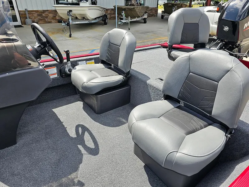 Slide: The Image of 2026 Tracker Bass Tracker Classic XL boat interior with gray seating and steering wheel. - 12