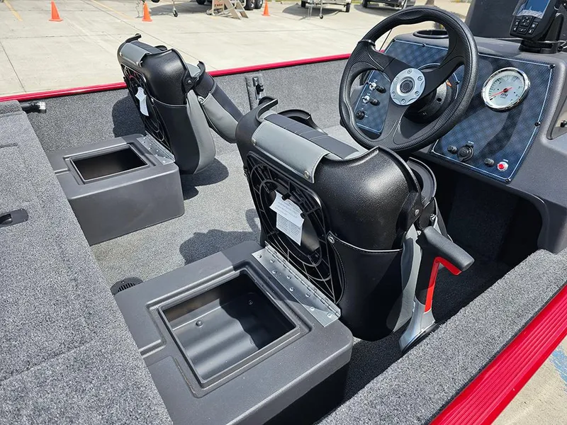 Slide: The Image of 2026 Tracker Bass Tracker Classic XL boat interior with steering wheel and seating. - 13