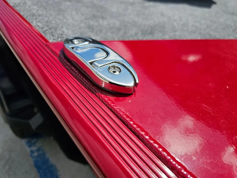 Slide: The Image of Close-up of a 2026 Tracker Bass Tracker Classic XL boat's red metallic surface and chrome detail. - 16