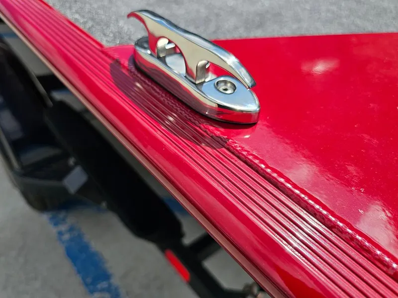 Slide: The Image of Red 2026 Tracker Bass Tracker Classic XL boat with chrome cleat detail. - 17