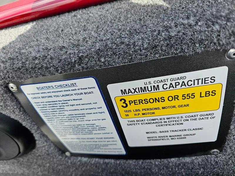 Slide: The Image of 2026 Tracker Bass Tracker Classic XL capacity label, showing maximum 3 persons or 555 lbs. - 20