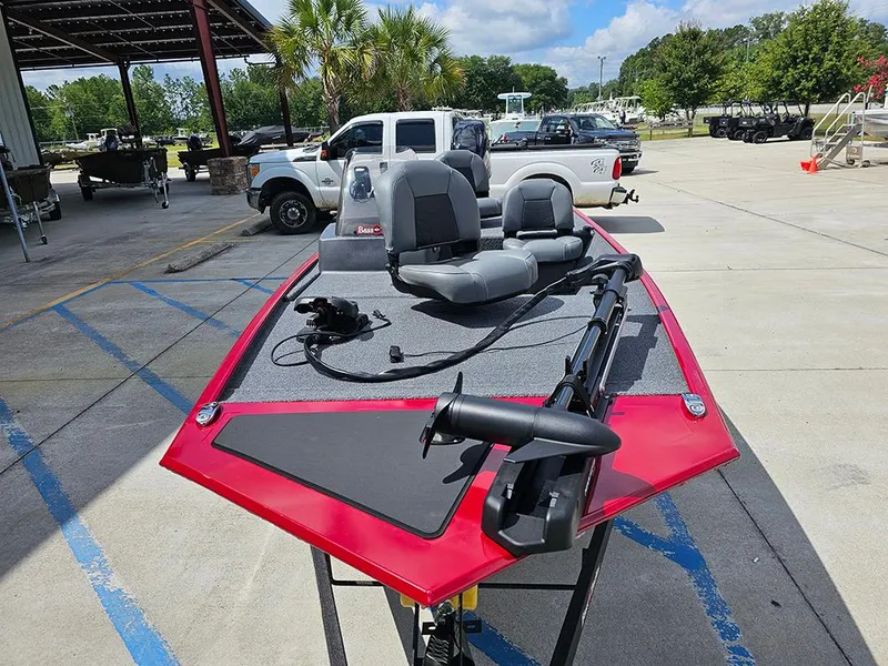 Slide: The Image of 2026 Tracker Bass Tracker Classic XL boat with red trim in a parking lot. - 4