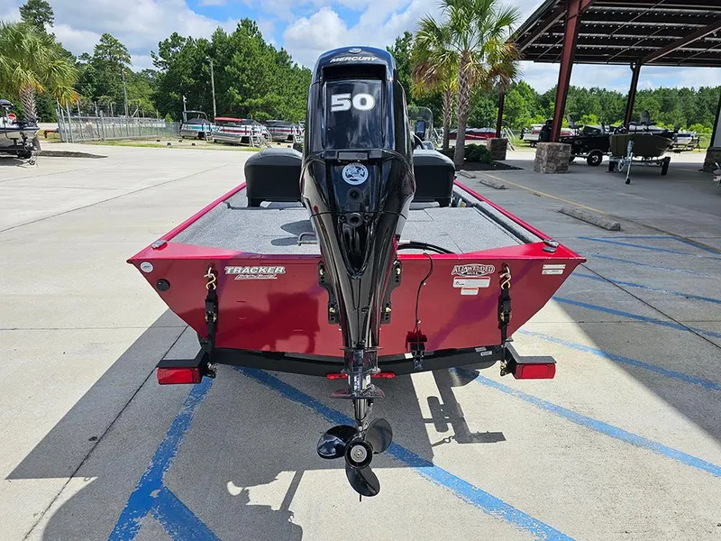 Slide: The Image of 2026 Tracker Bass Tracker Classic XL boat with Mercury 50 engine, parked outdoors. - 8