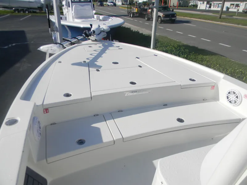 Slide: The Image of 2026 Pathfinder 2500 Hybrid boat deck with storage compartments and fishing rod holders. - 11