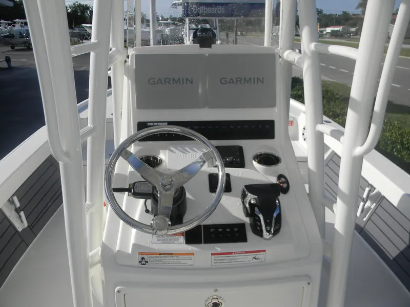 Slide: The Image of Pathfinder 2500 Hybrid 2026 boat console with Garmin navigation system and Yamaha steering wheel. - 3