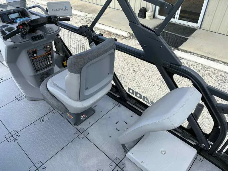 Slide: The Image of 2022 Sea-Doo SWITCH SPORT 21 boat interior with Garmin navigation system and seating. - 12