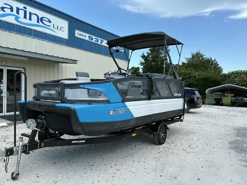 Slide: The Image of 2022 Sea-Doo SWITCH SPORT 21 boat on trailer outside marine dealership. - 2