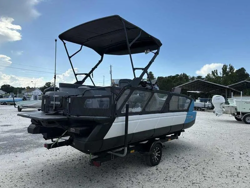 Slide: The Image of 2022 Sea-Doo SWITCH SPORT 21 boat on trailer, parked outdoors under clear sky. - 3