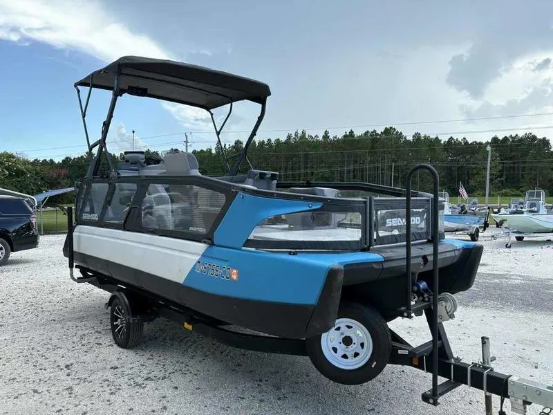 Slide: The Image of 2022 Sea-Doo SWITCH SPORT 21 boat on trailer, parked outdoors, under cloudy sky. - 4