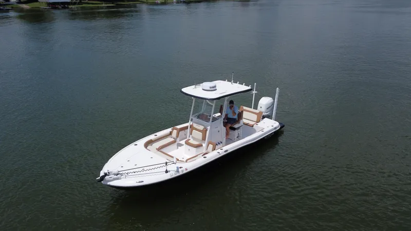 Slide: The Image of 2023 Caymas 26 HB boat on calm water, featuring sleek design and modern amenities. - 10