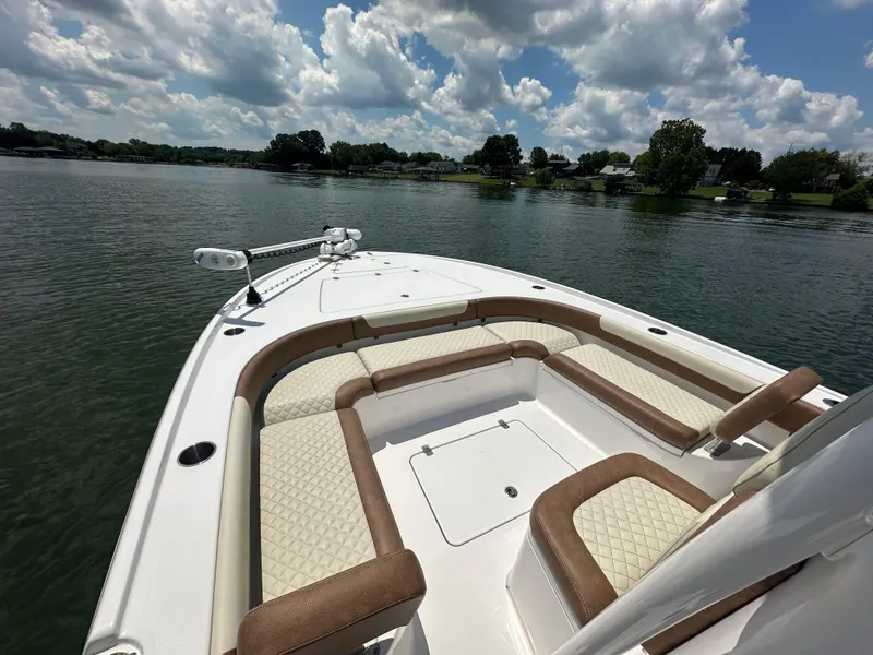 Slide: The Image of 2023 Caymas 26 HB boat on a lake under a partly cloudy sky. - 13