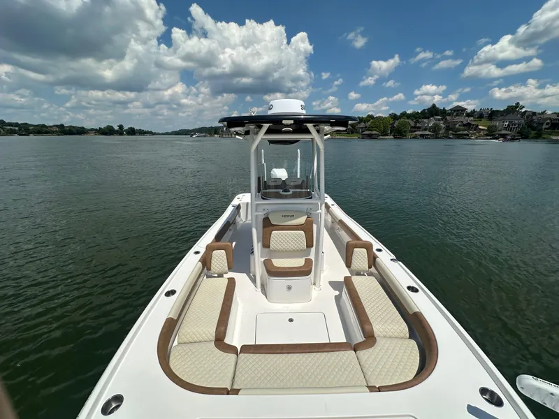 Slide: The Image of 2023 Caymas 26 HB boat on a lake under a partly cloudy sky. - 16