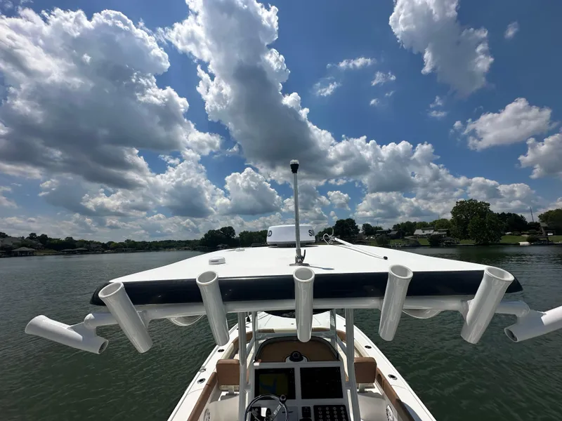 Slide: The Image of 2023 Caymas 26 HB boat on a lake under a partly cloudy sky. - 21