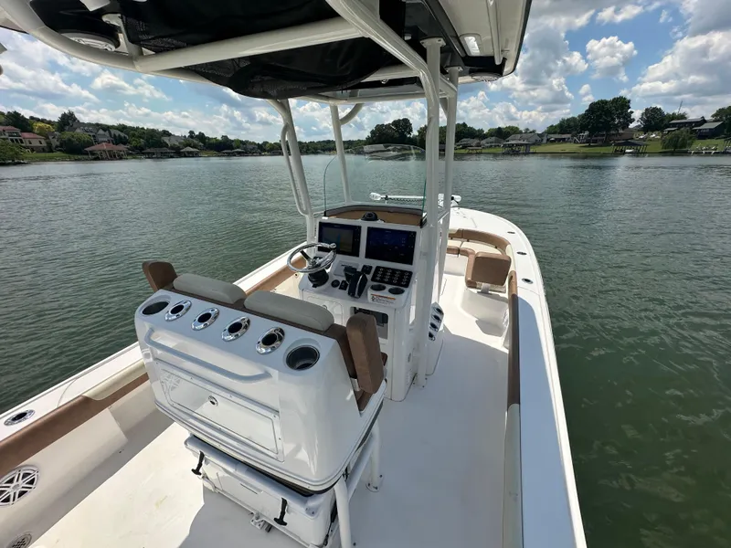Slide: The Image of 2023 Caymas 26 HB boat on a serene lake with clear skies. - 22