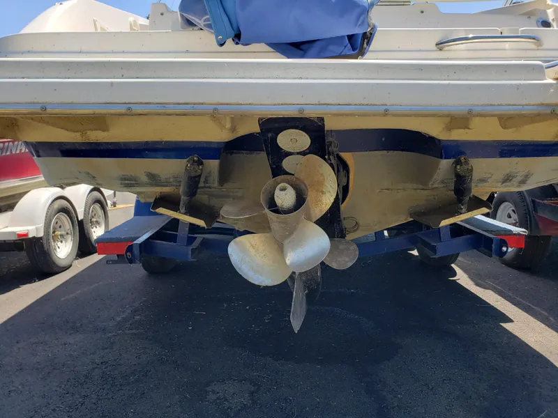 Slide: The Image of Rear view of a 2005 Rinker 232 Captiva Cuddy boat on a trailer. - 2