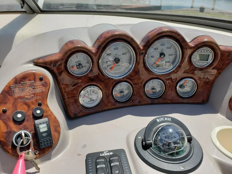 Slide: The Image of Dashboard of a 2005 Rinker 232 Captiva Cuddy boat with gauges and compass. - 5