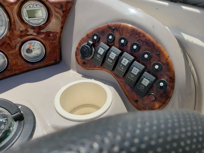 Slide: The Image of Control panel of a 2005 Rinker 232 Captiva Cuddy boat with switches and gauges. - 6