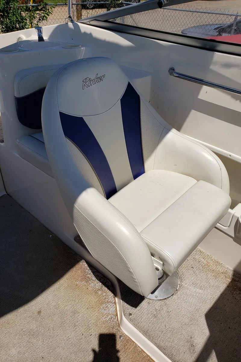 Slide: The Image of 2005 Rinker 232 Captiva Cuddy boat seat with blue and white upholstery. - 8