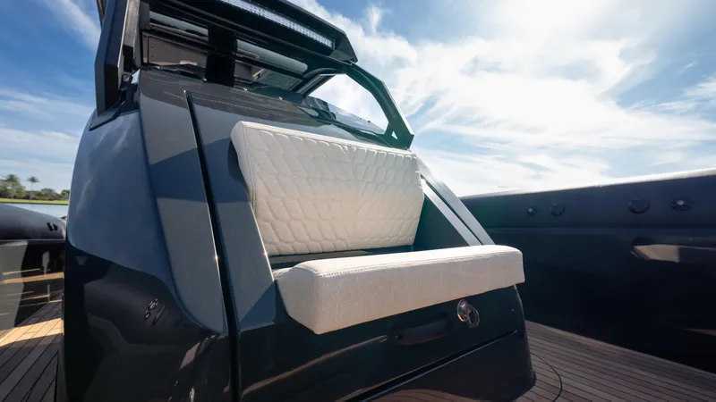 Slide: The Image of 2025 Skipper-BSK 38NC boat with sleek design and cushioned seating under a clear blue sky. - 19