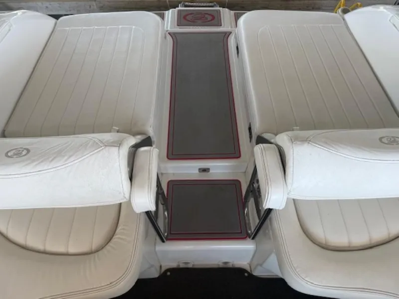 Slide: The Image of 2001 Cobalt 360 boat interior with white cushioned seating and central walkway. - 10