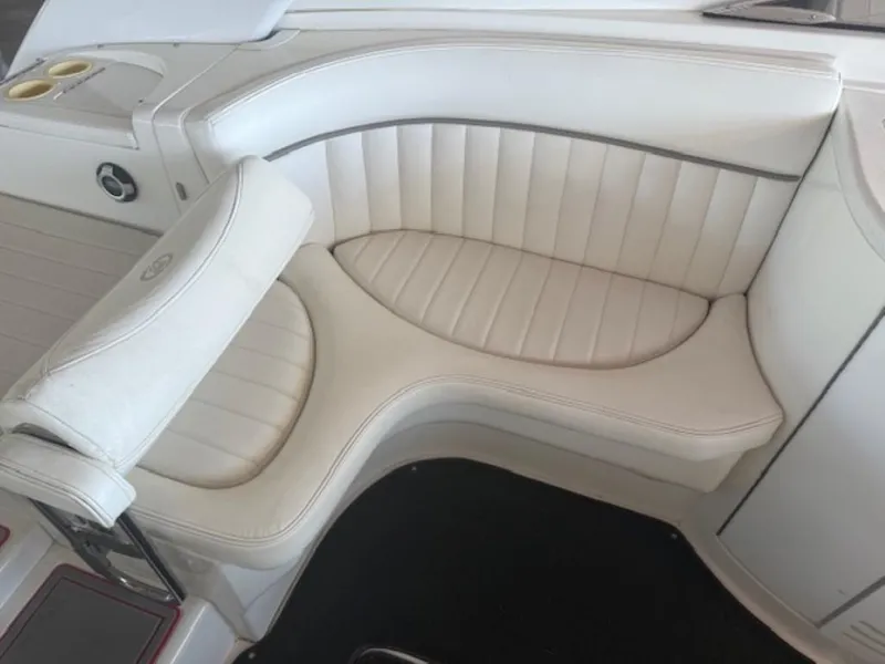 Slide: The Image of White leather seating on a 2001 Cobalt 360 boat, featuring cup holders and sleek design. - 11