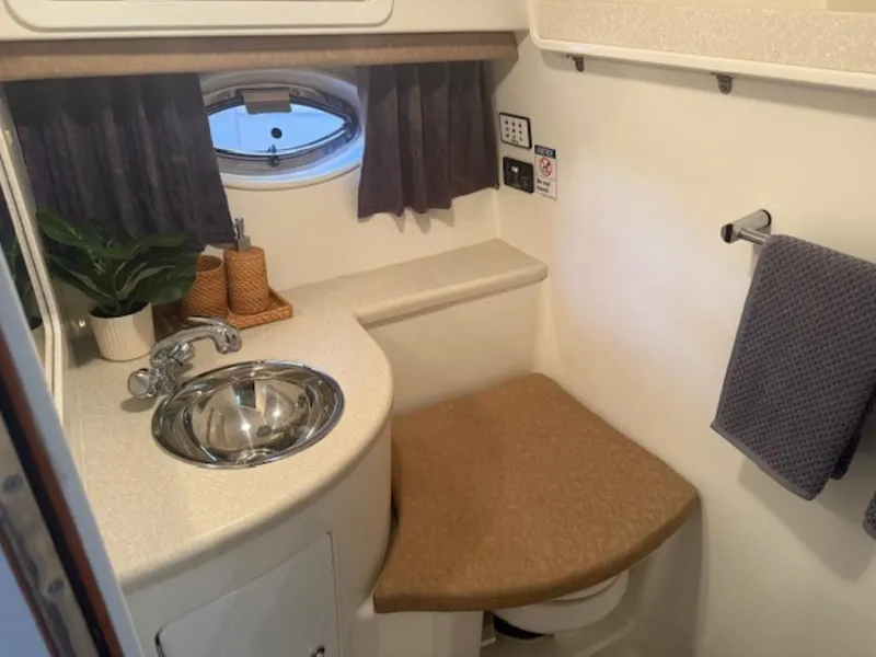 Slide: The Image of Compact bathroom in 2001 Cobalt 360 boat with sink, window, and towel rack. - 19