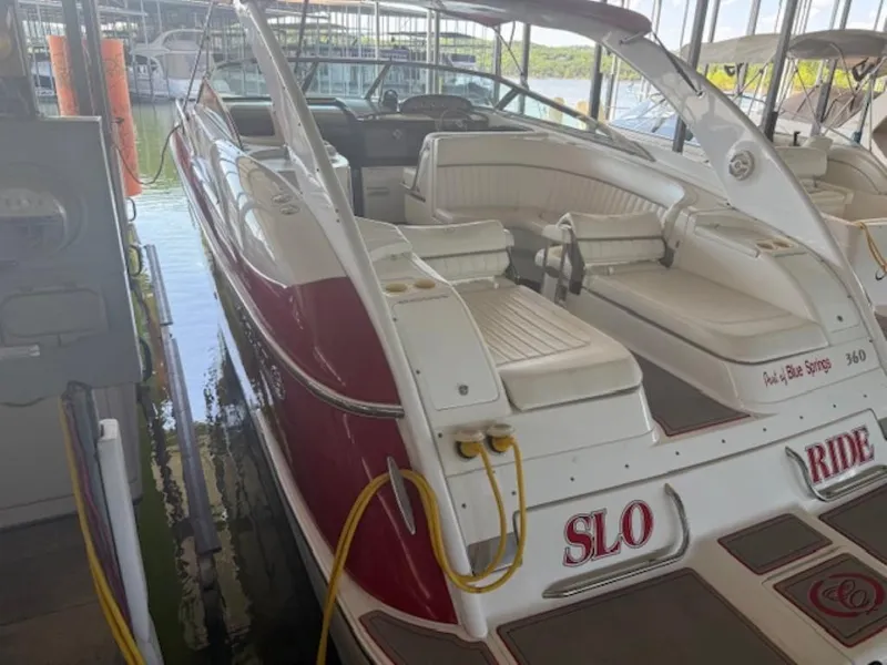 Slide: The Image of 2001 Cobalt 360 boat docked, featuring white and red design with spacious seating. - 4