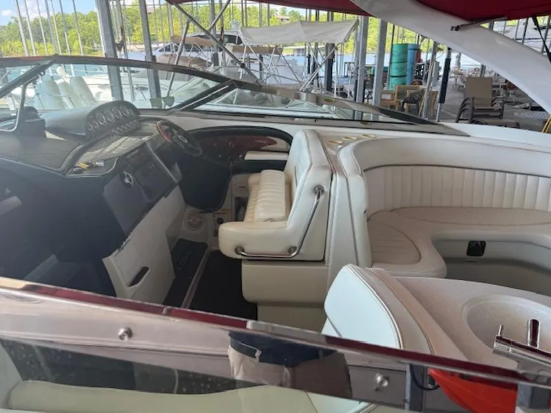 Slide: The Image of Interior of a 2001 Cobalt 360 boat with white leather seating and dashboard. - 6