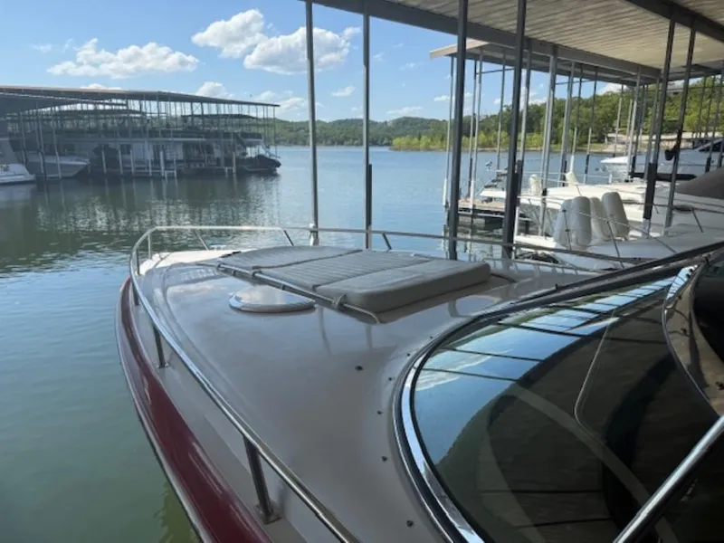 Slide: The Image of 2001 Cobalt 360 boat docked at a marina with scenic lake view. - 7