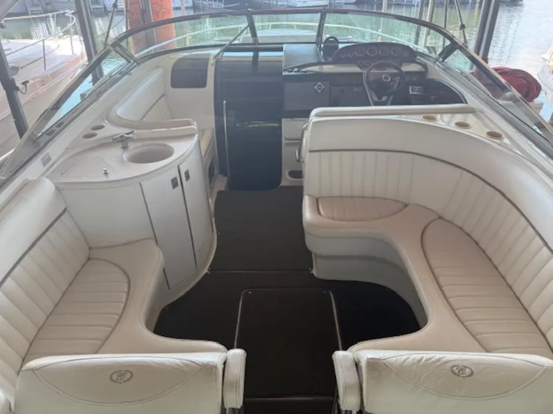 Slide: The Image of Interior of a 2001 Cobalt 360 boat with white leather seating and a compact sink. - 9