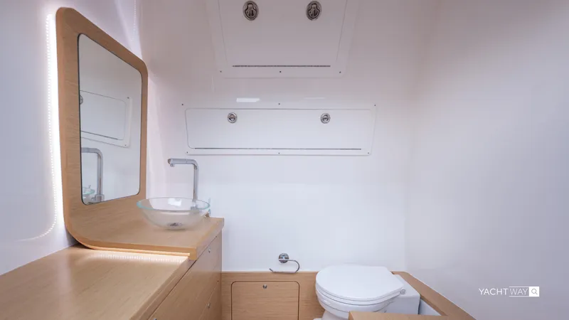 Slide: The Image of Modern yacht bathroom with wooden vanity, glass sink, and toilet on Skipper-BSK 38NC, 2025 model. - 34