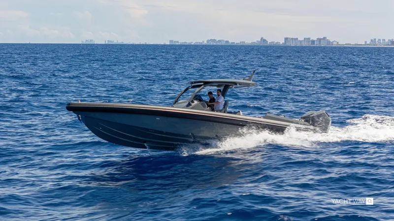 Slide: The Image of Skipper-BSK 38NC 2025 boat cruising on open sea with city skyline in background. - 8