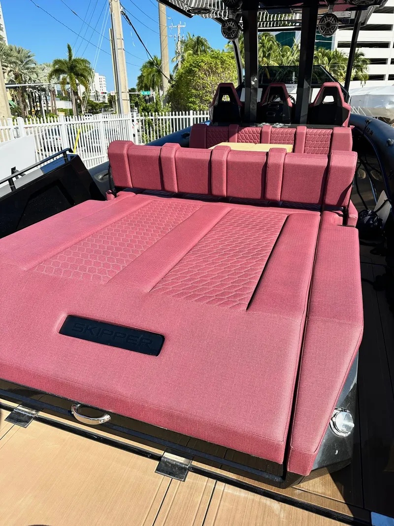 Slide: The Image of Luxurious 2025 Skipper-BSK 42NC boat with plush red seating and modern design. - 16