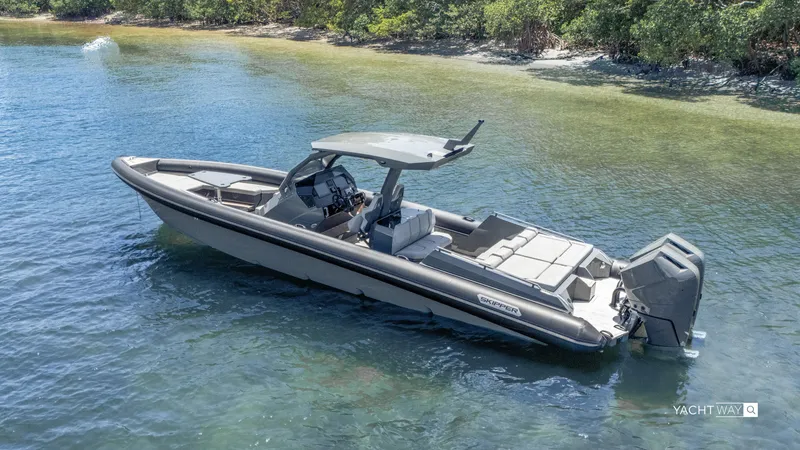 Slide: The Image of 2025 Skipper-BSK 38NC boat in shallow water near a forested shoreline. - 10