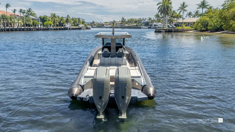Slide: The Image of 2025 Skipper-BSK 38NC yacht on a scenic waterway with palm trees. - 12