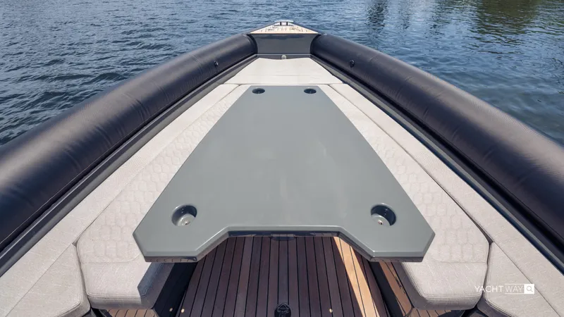 Slide: The Image of Skipper-BSK 38NC 2025 boat deck with seating, on calm water. - 23