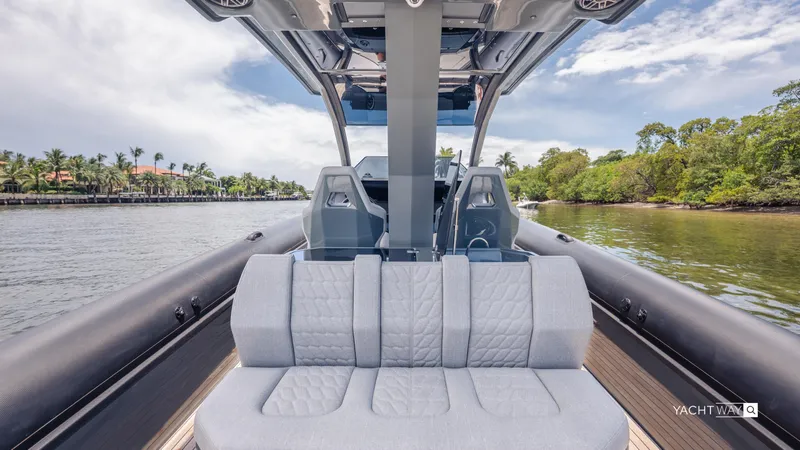 Slide: The Image of 2025 Skipper-BSK 38NC boat interior with plush seating, cruising on a scenic waterway. - 39