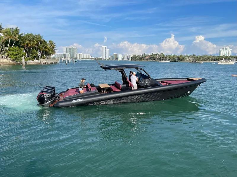 Slide: The Image of 2025 Skipper-BSK 42NC boat cruising on a sunny day near a tropical coastline. - 11