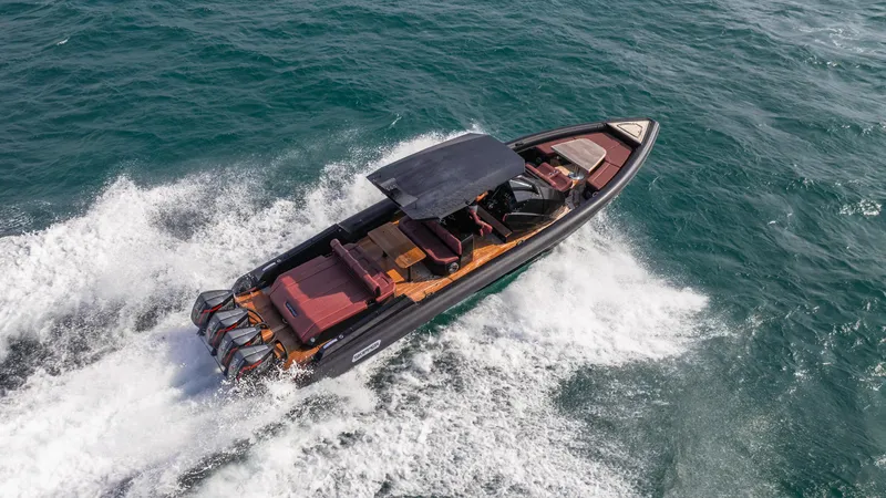 Slide: The Image of 2025 Skipper-BSK 42NC speedboat cruising on open water, showcasing sleek design and powerful engines. - 3