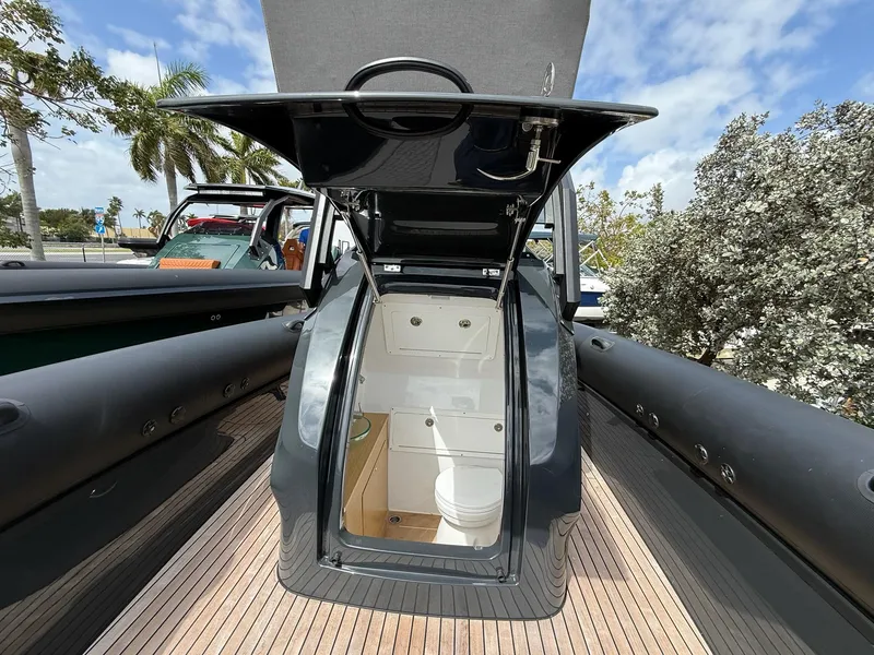 Slide: The Image of Skipper-BSK 38NC 2025 boat with open hatch revealing interior cabin and toilet. - 15