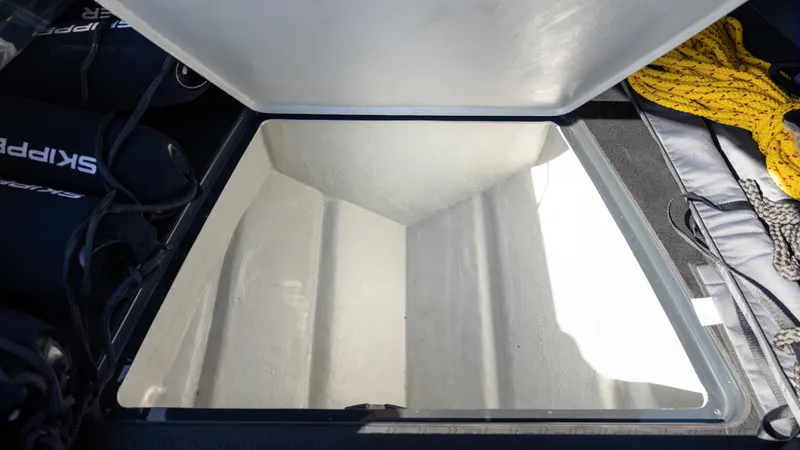 Slide: The Image of Open storage compartment on Skipper-BSK 38NC boat, 2025 model, with ropes and equipment nearby. - 21